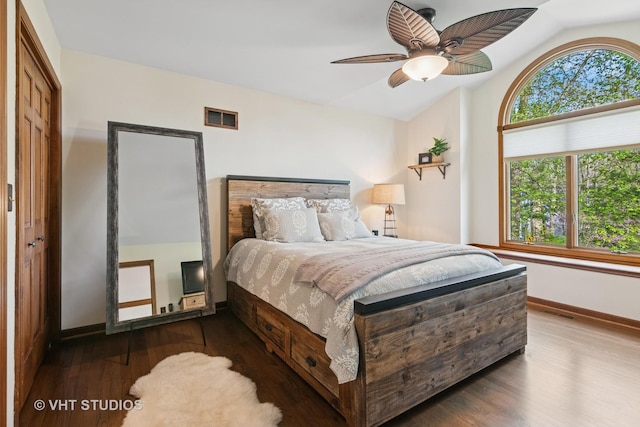 42W142 Ravine Dr, Saint Charles, IL 60175 - bedroom featuring vaulted ceiling, multiple windows, wood finished floors, baseboards, and ceiling fan