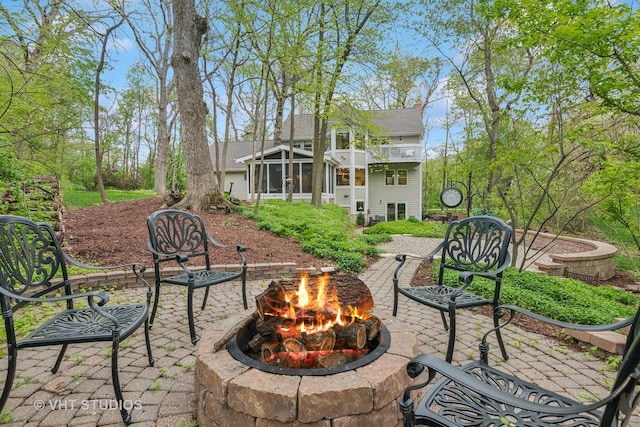 42W142 Ravine Dr, Saint Charles, IL 60175 - view of patio / terrace with an outdoor fire pit and a sunroom