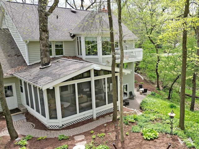 42W142 Ravine Dr, Saint Charles, IL 60175 - back of house with a shingled roof, a sunroom, and a balcony