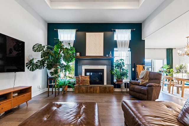 840 Coventry Cir N, Sycamore, IL 60178 - living area featuring a fireplace, a raised ceiling, hardwood / wood-style floors, and a notable chandelier