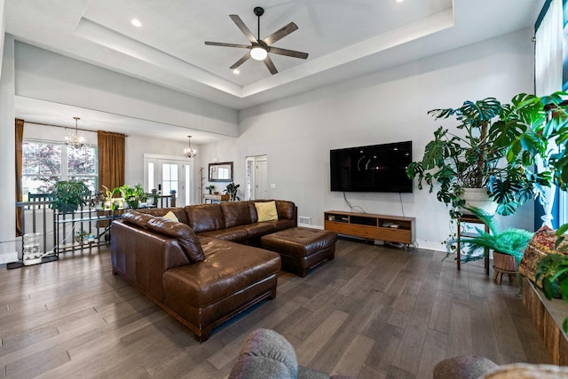 840 Coventry Cir N, Sycamore, IL 60178 - living room featuring a raised ceiling, ceiling fan with notable chandelier, and wood finished floors