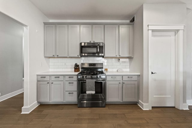 840 Coventry Cir N, Sycamore, IL 60178 - kitchen with dark wood finished floors, gray cabinetry, and appliances with stainless steel finishes