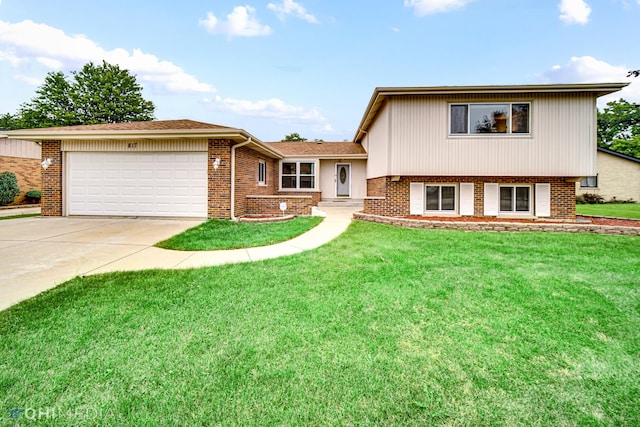 split level home with an attached garage, concrete driveway, brick siding, and a front yard