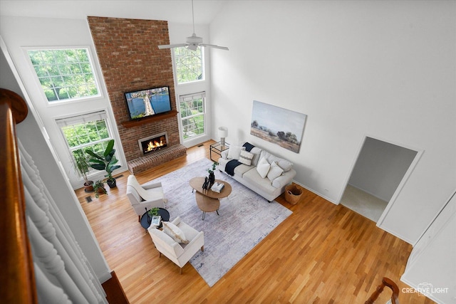 4012 Heron Ct, Naperville, IL 60564 - living room featuring wood finished floors, a fireplace, a high ceiling, and a ceiling fan