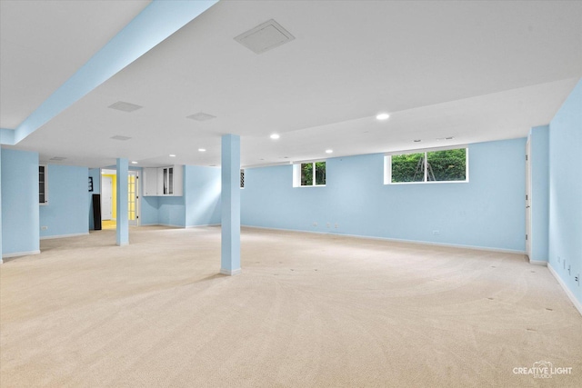 below grade area with light carpet, recessed lighting, and baseboards