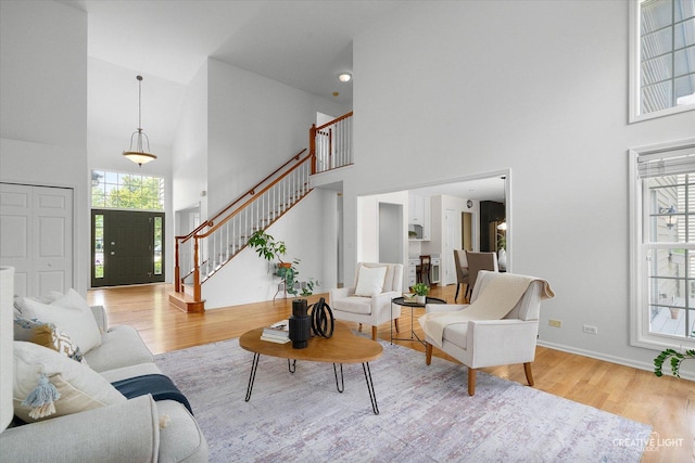 4012 Heron Ct, Naperville, IL 60564 - living room with a towering ceiling, stairs, and wood finished floors