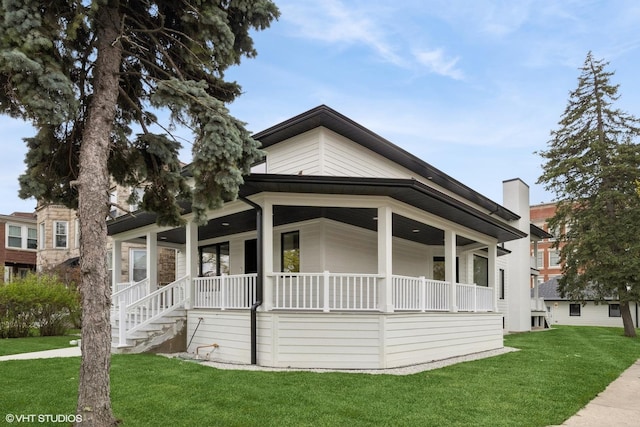 bungalow-style house with covered porch and a front lawn