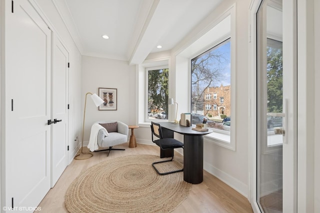 living area with recessed lighting, baseboards, plenty of natural light, and light wood finished floors