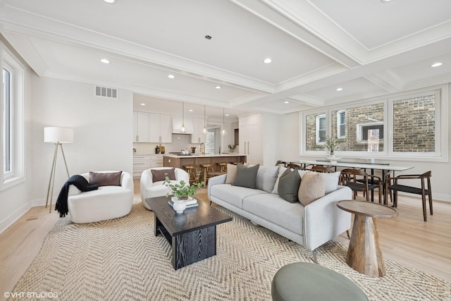 living room with recessed lighting, baseboards, light wood-style flooring, and beam ceiling
