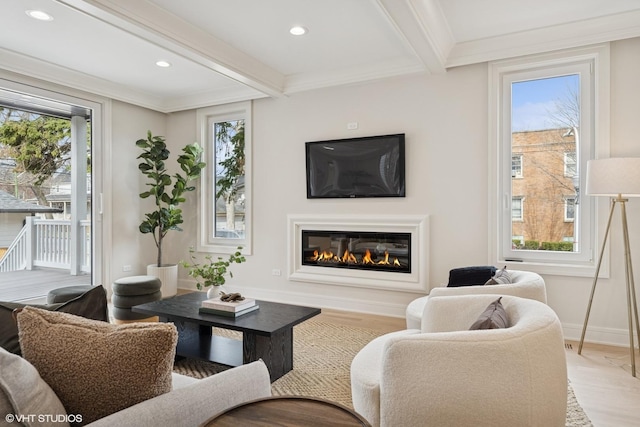 living room featuring a glass covered fireplace, light wood-style flooring, recessed lighting, and beam ceiling