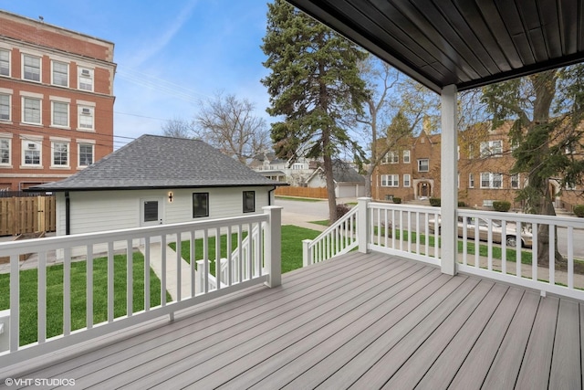 wooden deck featuring a lawn