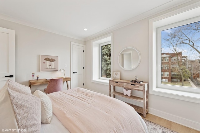 bedroom featuring baseboards, ornamental molding, wood finished floors, and recessed lighting