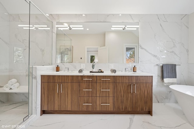 full bathroom with tile walls, a soaking tub, a marble finish shower, and marble finish floor