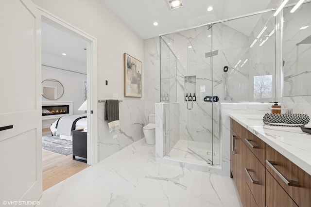 full bath with a marble finish shower, vanity, and recessed lighting