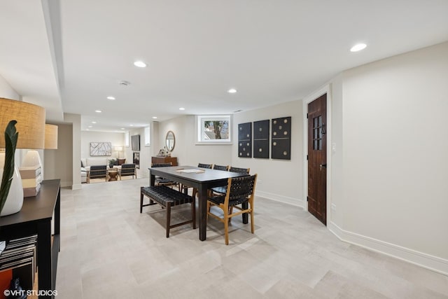 dining space with recessed lighting and baseboards