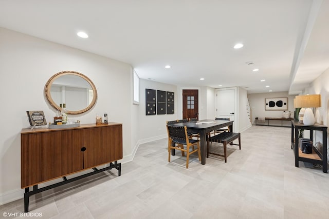 dining room with baseboards and recessed lighting