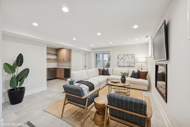 living room featuring recessed lighting, baseboards, and indoor bar