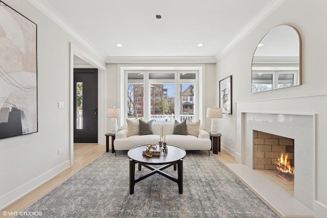 living room featuring baseboards, ornamental molding, wood finished floors, and a premium fireplace