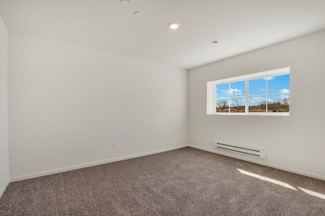 spare room featuring carpet floors, recessed lighting, baseboards, and a baseboard heating unit