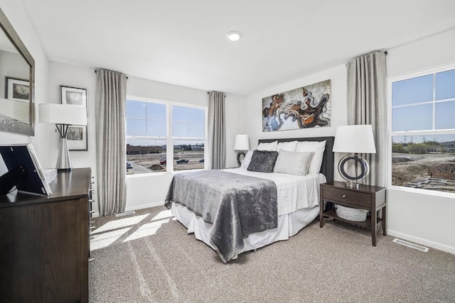 bedroom featuring baseboards, visible vents, and carpet