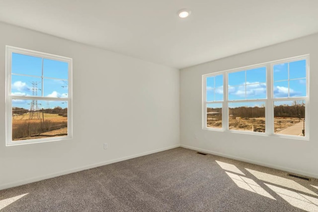 carpeted empty room with baseboards, recessed lighting, and visible vents