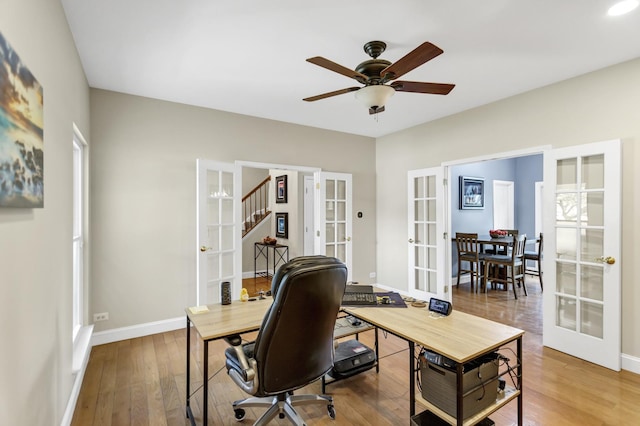 office space with baseboards, a ceiling fan, french doors, and wood finished floors
