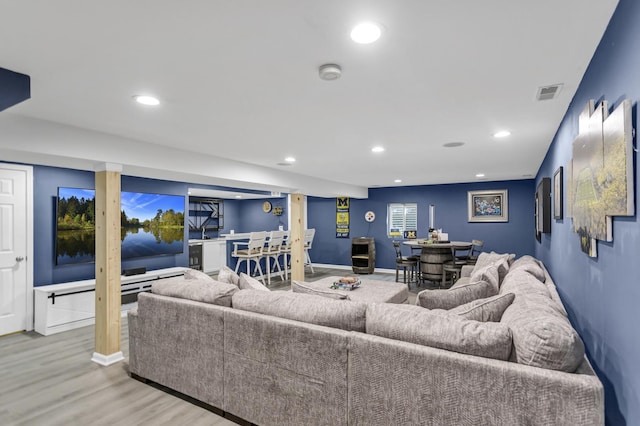 living area featuring recessed lighting, baseboards, visible vents, and wood finished floors
