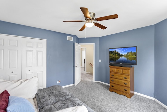 bedroom featuring a closet, carpet flooring, baseboards, and visible vents