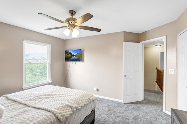 bedroom featuring baseboards, a ceiling fan, and light colored carpet