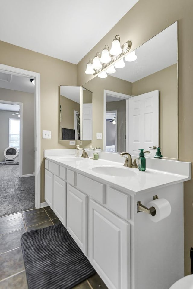 bathroom featuring double vanity, a sink, and tile patterned flooring