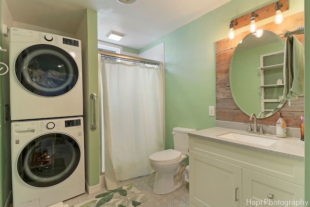 bathroom with vanity, stacked washer and clothes dryer, curtained shower, and toilet