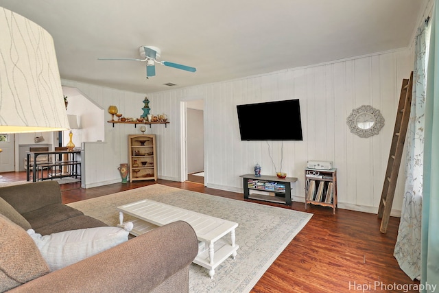 living room featuring a ceiling fan, wood finished floors, and visible vents