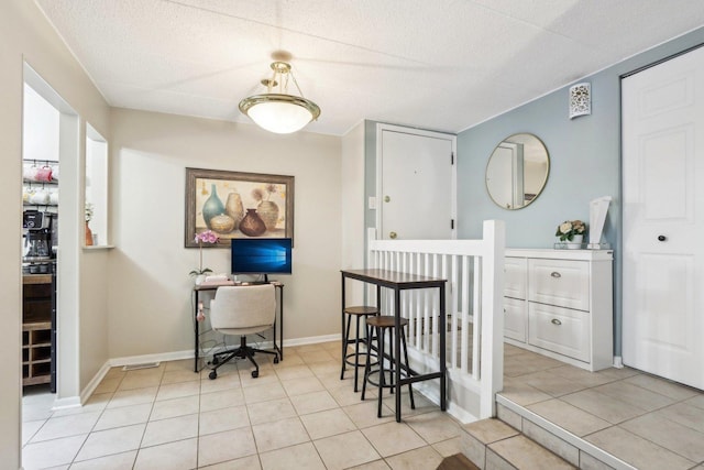 dining room with baseboards and light tile patterned floors