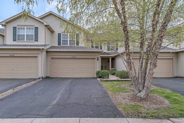view of property featuring a garage and driveway