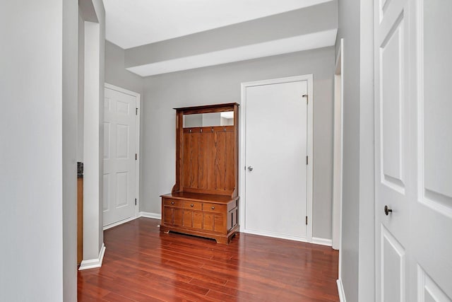 hallway featuring baseboards and wood finished floors