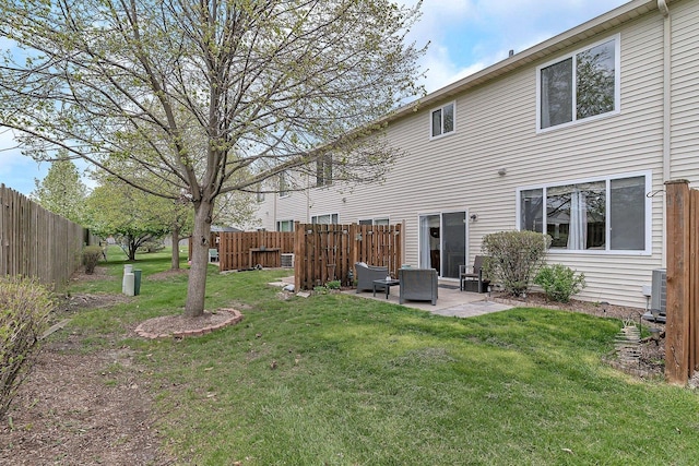back of property featuring a yard, fence, and a patio area
