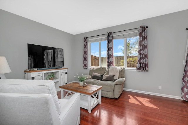 living area featuring dark wood-type flooring and baseboards