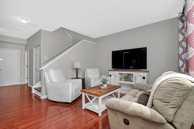 living room with wood finished floors and stairway
