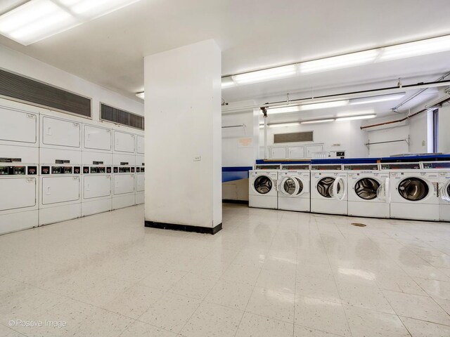 405 N Wabash Ave Unit 2315, Chicago, IL 60611 - common laundry area featuring tile patterned floors, stacked washer and dryer, and washer and dryer