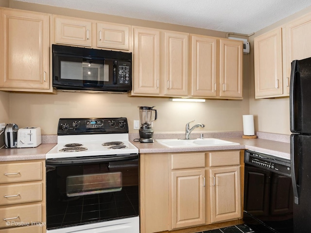 405 N Wabash Ave Unit 2315, Chicago, IL 60611 - kitchen featuring a sink, light brown cabinetry, black appliances, and light countertops
