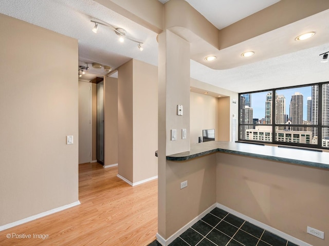 405 N Wabash Ave Unit 2315, Chicago, IL 60611 - kitchen with baseboards, a city view, wood finished floors, and recessed lighting