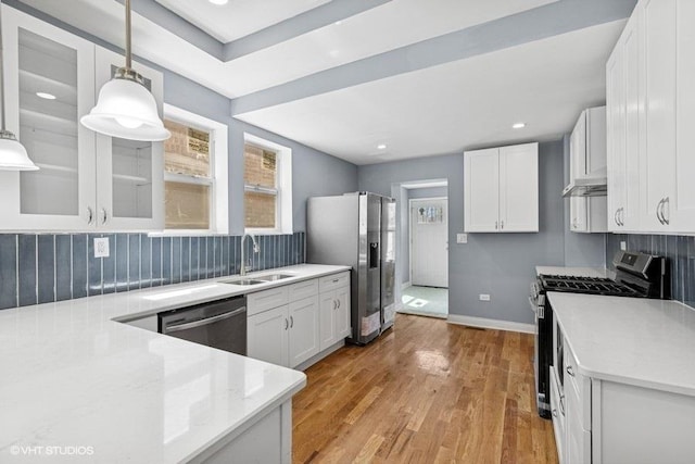kitchen with light countertops, a sink, white cabinetry, and stainless steel appliances