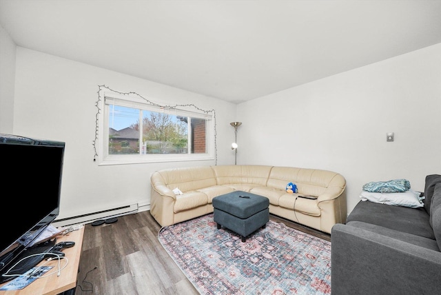 living area featuring a baseboard heating unit and wood finished floors