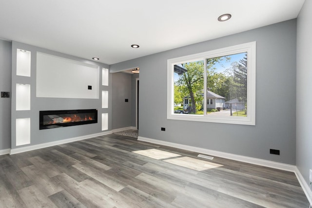 16910 Lincoln St, Hazel Crest, IL 60429 - unfurnished living room featuring a glass covered fireplace, wood finished floors, baseboards, and recessed lighting
