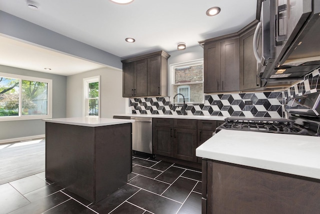 16910 Lincoln St, Hazel Crest, IL 60429 - kitchen featuring appliances with stainless steel finishes, dark brown cabinetry, backsplash, a sink, and a kitchen island