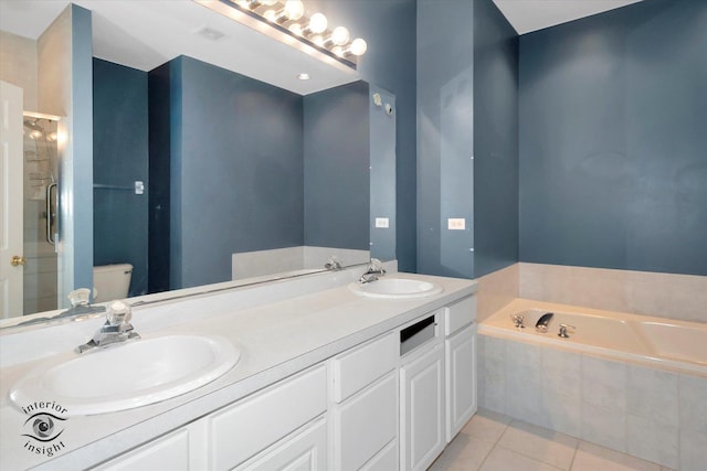 bathroom featuring tile patterned floors, a sink, a bath, and a stall shower