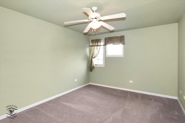 carpeted empty room featuring baseboards and ceiling fan