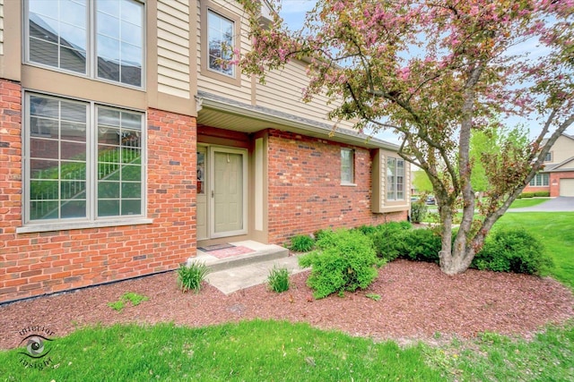 doorway to property featuring brick siding
