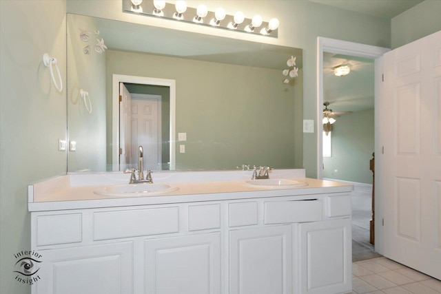 full bathroom with double vanity, a sink, a ceiling fan, and tile patterned floors