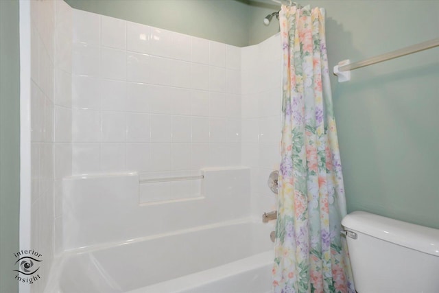 bathroom with toilet and shower / bath combination with curtain
